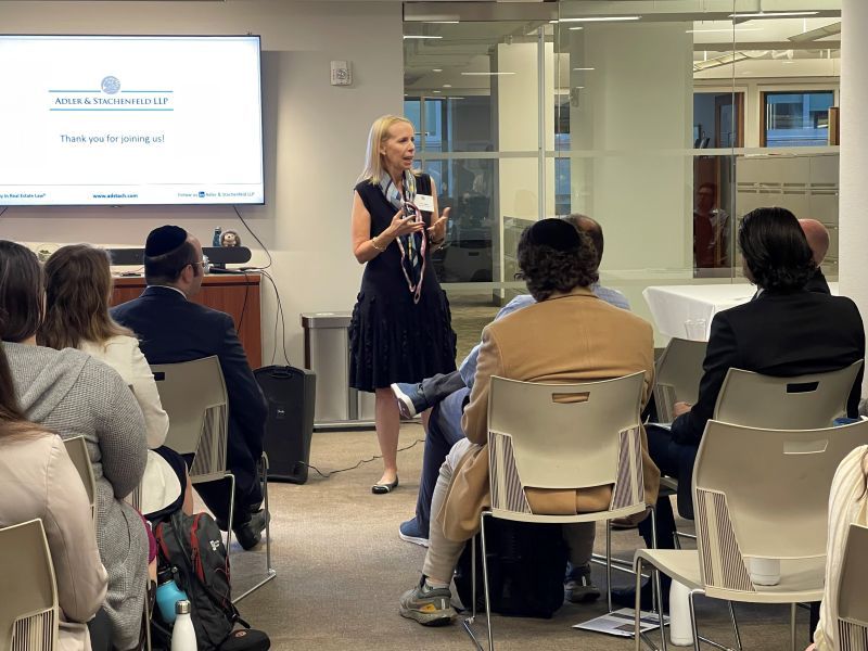 a color photo of Terri Adler at A&S speaking to a group of law students